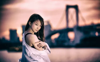 Woman in White Shirt Against Blurred City Skyline - free wallpaper 7680×4792