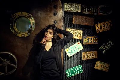 Woman in Black Jacket Against Industrial Wall with License Plates - free people & portraits wallpaper 2048×1365