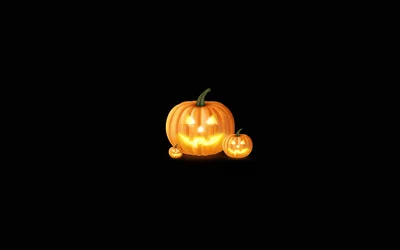 Glowing Jack-O'-Lanterns on Black Background - free wallpaper 2560×1600
