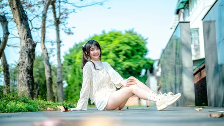 Young Woman Sitting on Pathway in Urban Garden - free people & portraits wallpaper 4562×2566