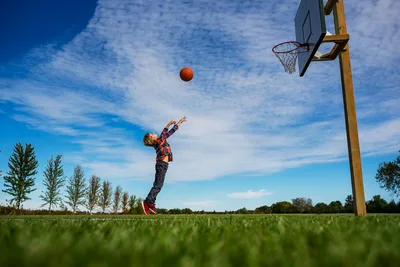 Young Player Shooting Basketball Outdoors - free wallpaper 6016×4016