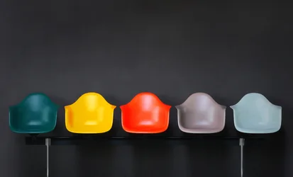 Five Colorful Modern Chairs Against Dark Wall - free photography wallpaper 7680×4646