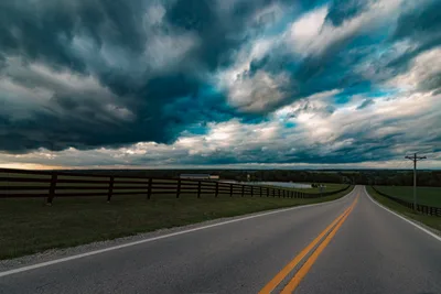 Rural Highway Stretching Into Stormy Skies - free city & urban wallpaper 7680×5126