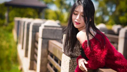 Woman in Red Fur Wrap by Stone Railing - free wallpaper 7680×4320
