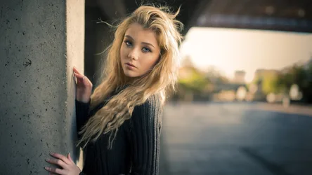 Woman Leaning Against Concrete Wall Outdoors - free wallpaper 7680×4320