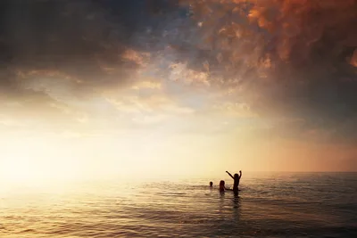 Silhouetted Figures Wading in Ocean at Sunset - free people & portraits wallpaper 6144×4096