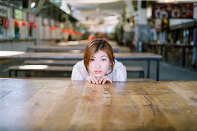 Woman Leaning on Table in Asian Temple Hall - free people & portraits wallpaper 2000×1336