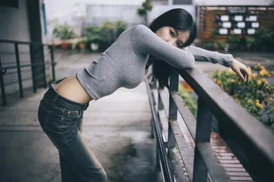 Woman Leaning on Rooftop Railing in Urban Setting - free people & portraits wallpaper 7680×5103