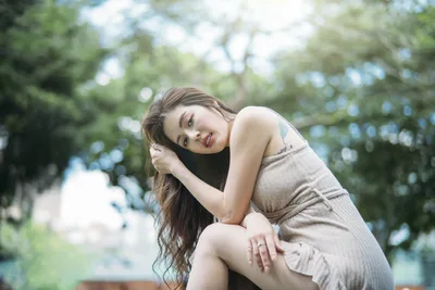 Woman in Beige Tank Top Posing Outdoors - free wallpaper 4000×2667
