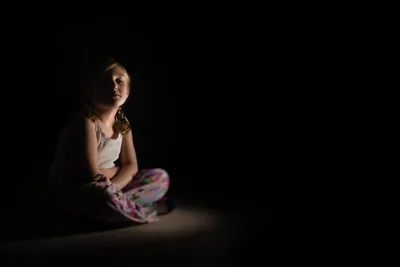 Young Girl Sitting in Dramatic Spotlight Against Black - free people & portraits wallpaper 6144×4096