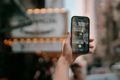 Hand Holding Smartphone Capturing Urban Street Scene - free city & urban wallpaper 6144×4096