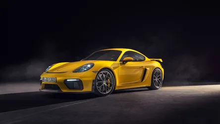 Yellow Porsche Cayman GT4 Sports Car on Dark Ground - free cars & vehicles wallpaper 5120×2880