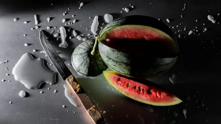 Watermelon Being Cut With Knife on Dark Surface - free wallpaper 3840×2160