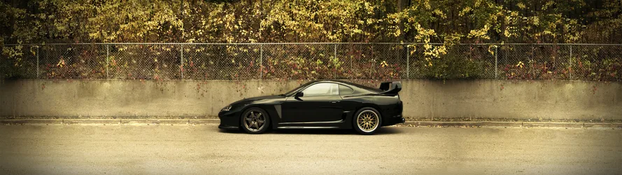 Black Toyota Supra Sports Car Against Urban Wall - free wallpaper 5120×1440