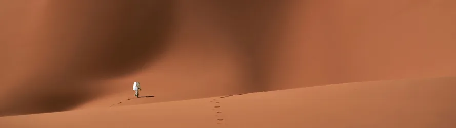 Astronaut Traversing an Alien Desert - free sci-fi wallpaper 5120×1440