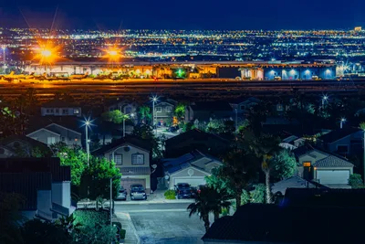 Suburban Neighborhood at Night with Industrial Port Lights - free city & urban wallpaper 7680×5120