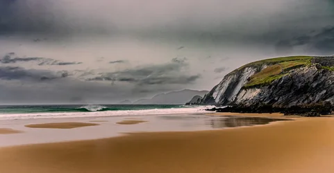 Dramatic Coastal Cliffs with Sandy Beach and Stormy Sky - free landscapes wallpaper 6144×3196