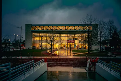 Modern Art Fair Building at Twilight with Wet Pavement - free city & urban wallpaper 7680×5123