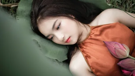 Asian Woman Lying with Lotus Flowers in Orange Dress - free wallpaper 7680×4320