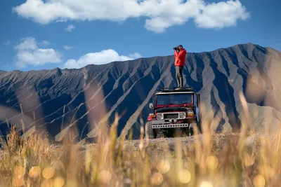 Man Photographing Mountain Landscape From Jeep Roof - free people & portraits wallpaper 6144×4098