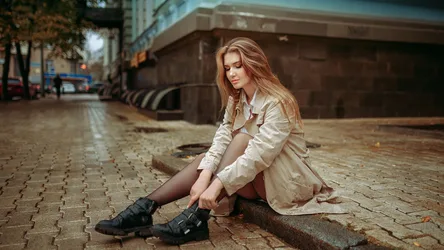 Girl in City Street Sitting on Wet Pavement - free wallpaper 2048×1152